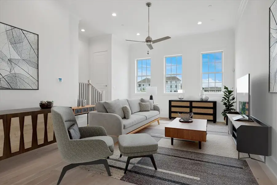 Living area with light wood-style floors, ceiling fan, recessed lighting, and crown molding
