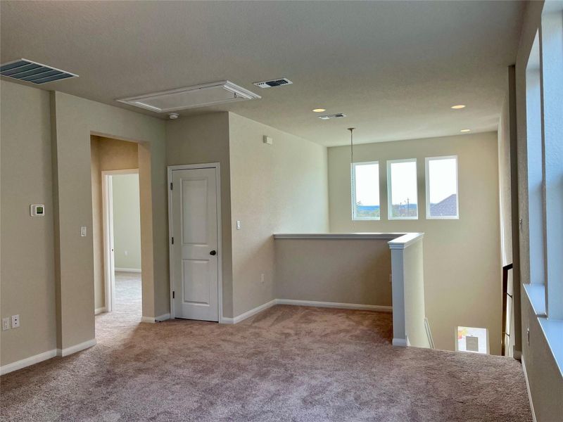 Spare room featuring carpet and attic access Spare room featuring carpet and attic access