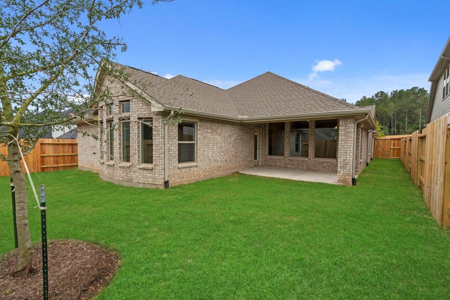 Exterior details and patio area of a home in Wildtree, Magnolia (Image 22).