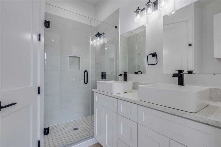 Primary bathroom on main floor with dual vanity and quartz countertops Primary bathroom on main floor with dual vanity and quartz countertops