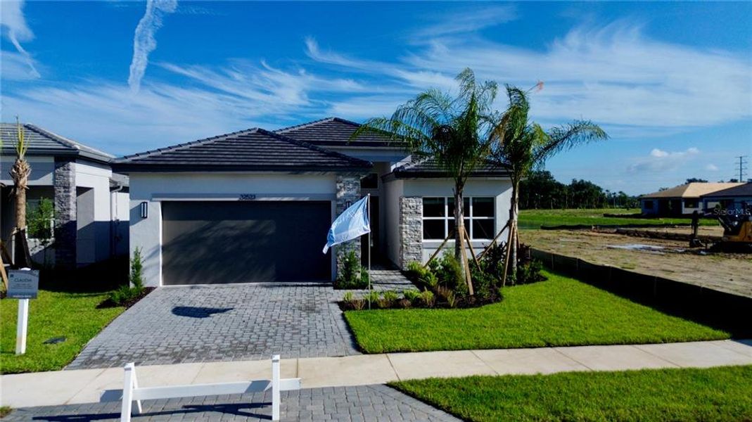 Front exterior of a new home in Valencia Ridge, Wesley Chapel, FL, highlighting curb appeal (Image 25).