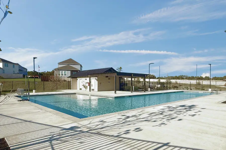 An inviting community pool awaits, featuring a covered cabana and ample deck space for relaxation.