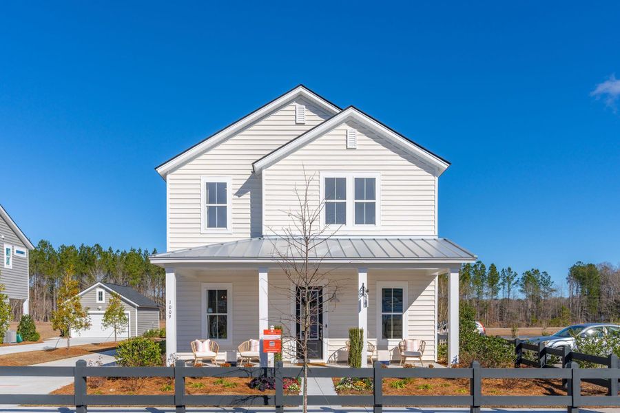 Front exterior of a new home in Sweetgrass at Summers Corner: Row Collection, Summerville, SC, highlighting curb appeal (Image 18).