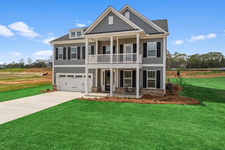 Front exterior of a new home in Foxhall Landing, Easley, SC, highlighting curb appeal (Image 2). Front exterior of a new home in Foxhall Landing, Easley, SC, highlighting curb appeal (Image 2).