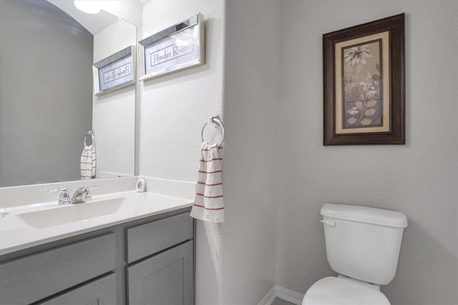 Inviting Powder Room with sleek vanity and modern fixtures, perfect for guests.