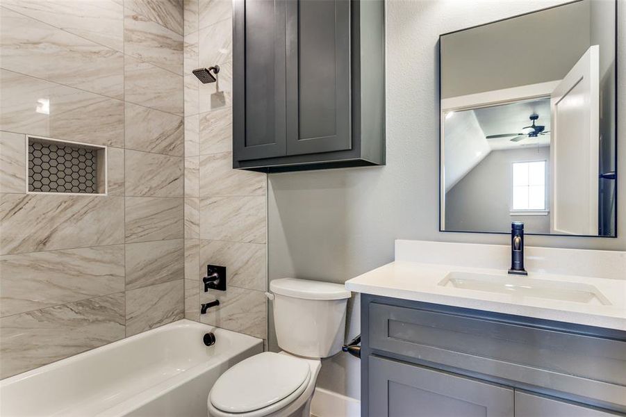 Bathroom with vanity, shower / washtub combination, and a ceiling fan Bathroom with vanity, shower / washtub combination, and a ceiling fan