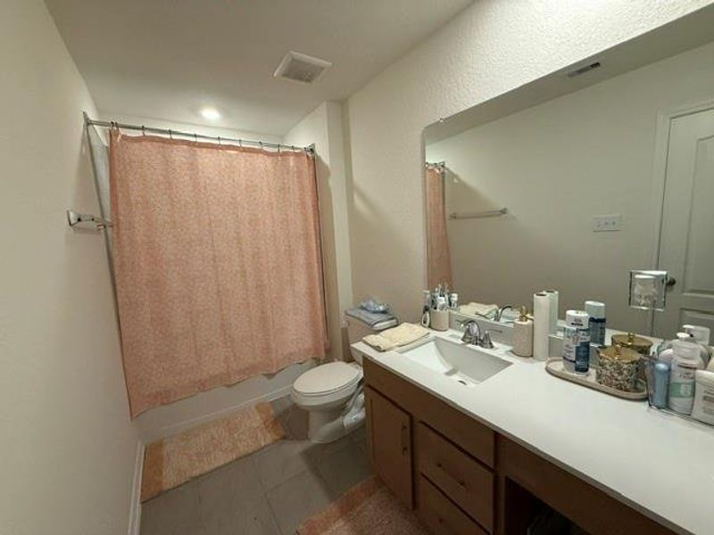 Full secondary bath with large vanity, oversized mirror, and tub/shower combo Full secondary bath with large vanity, oversized mirror, and tub/shower combo
