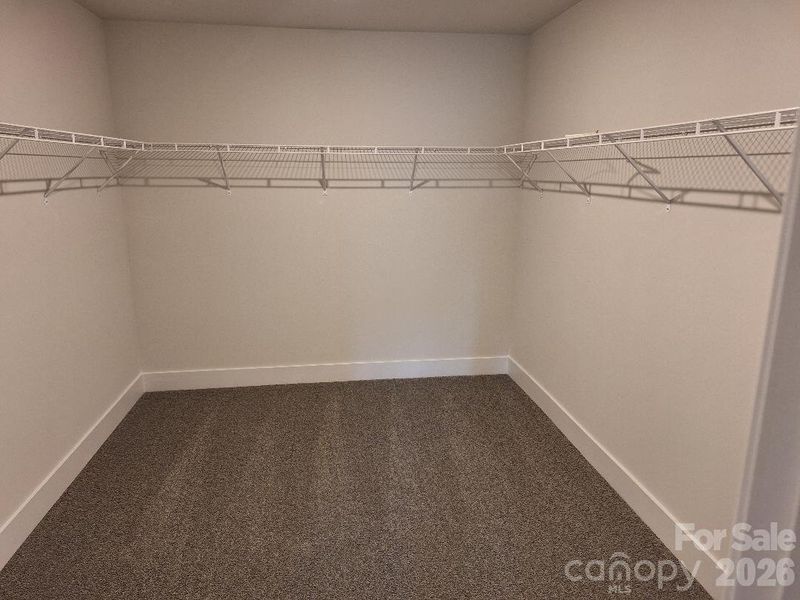 Primary Bedroom Walk-In Closet Primary Bedroom Walk-In Closet