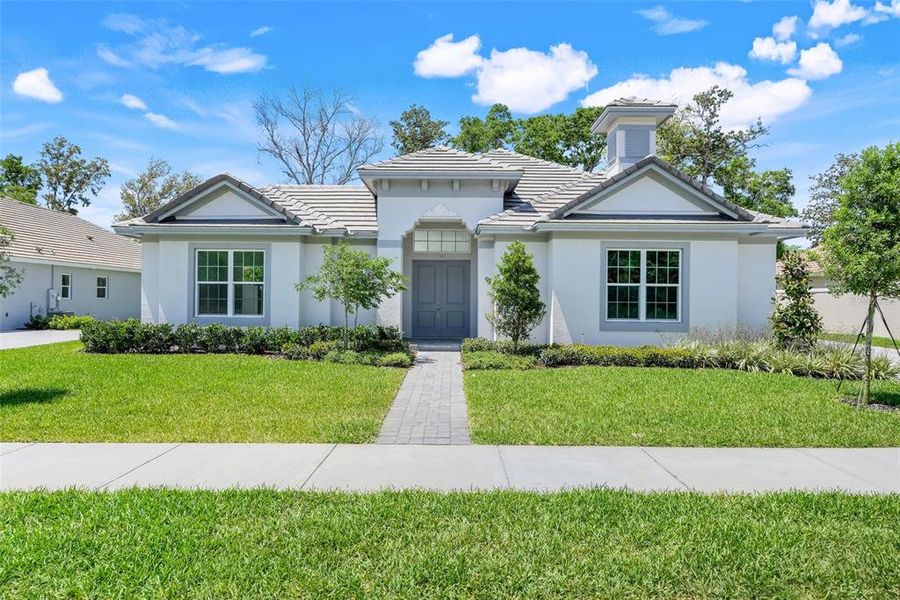 Front exterior of a new home in Toscana, Palm Coast, FL, highlighting curb appeal (Image 25). Front exterior of a new home in Toscana, Palm Coast, FL, highlighting curb appeal (Image 25).
