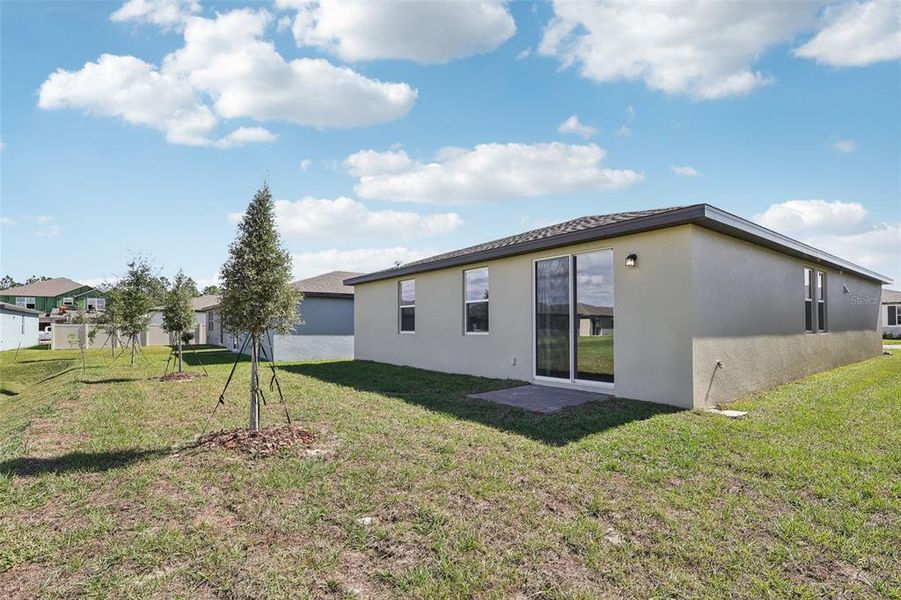 Exterior details and patio area of a home in Lake Deer Estates - Signature Series, Poinciana (Image 3).