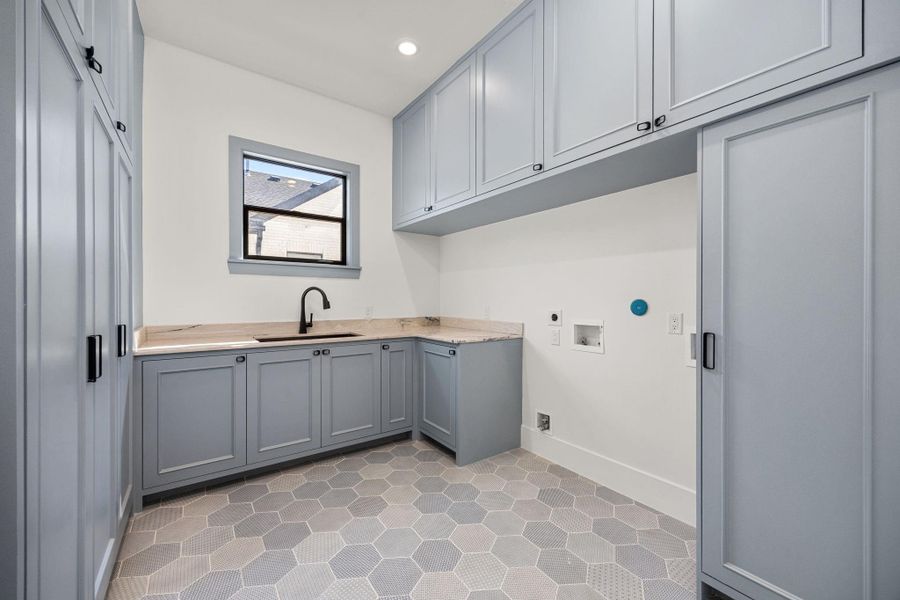 Spacious Laundry Room offers connections for TWO SETS of W/D, along with custom site-built cabinetry. Spacious Laundry Room offers connections for TWO SETS of W/D, along with custom site-built cabinetry.