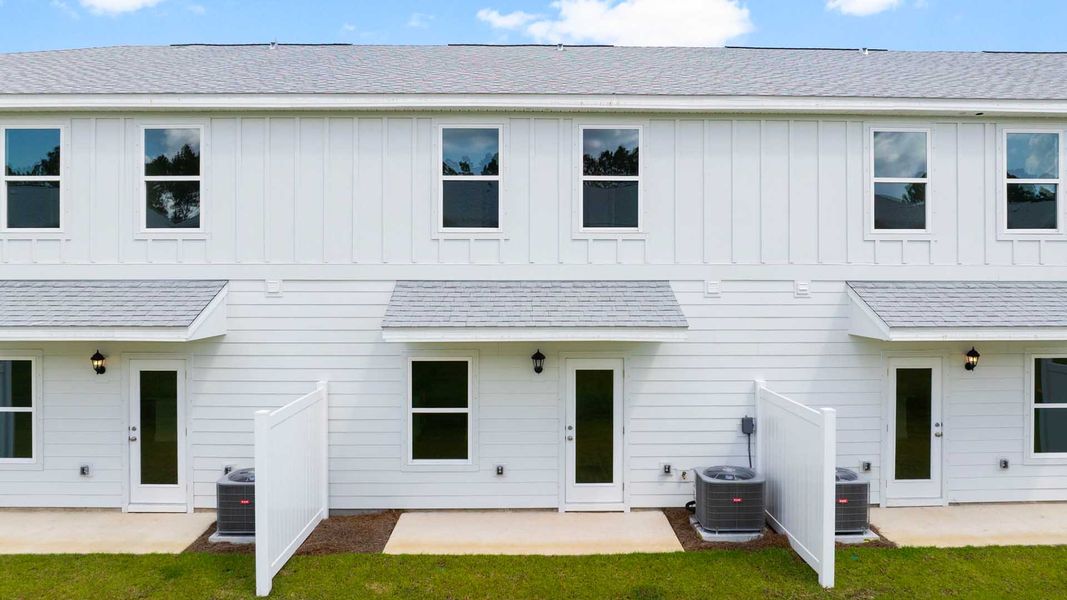 Front exterior of a new home in Genoa Landing Townhomes, Freeport, FL, highlighting curb appeal (Image 2).