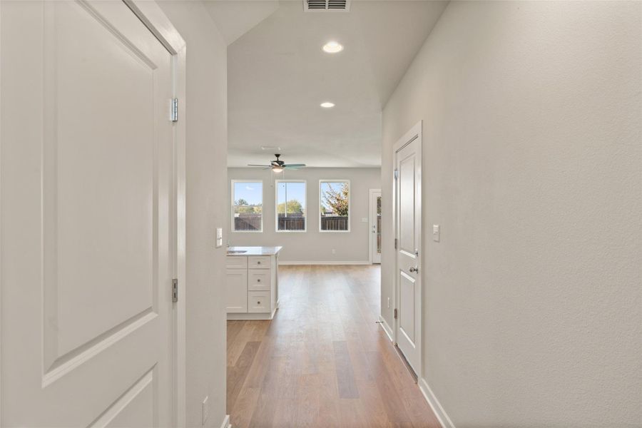 Hallway featuring light wood finished floors and recessed lighting Hallway featuring light wood finished floors and recessed lighting