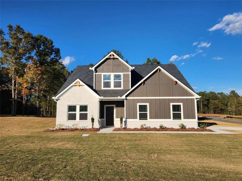 Front exterior of a new home in The Woodlands Preserve, Jackson, GA, highlighting curb appeal (Image 2).