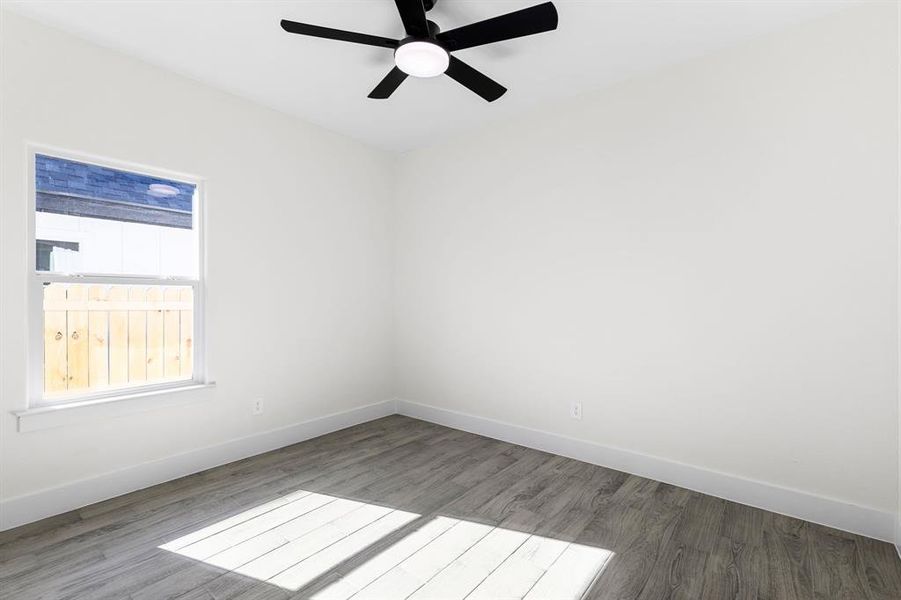 Empty room featuring ceiling fan and wood-type flooring