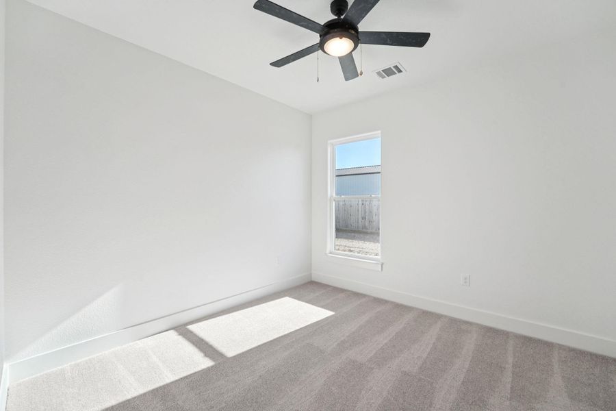 Spare room featuring carpet and baseboards