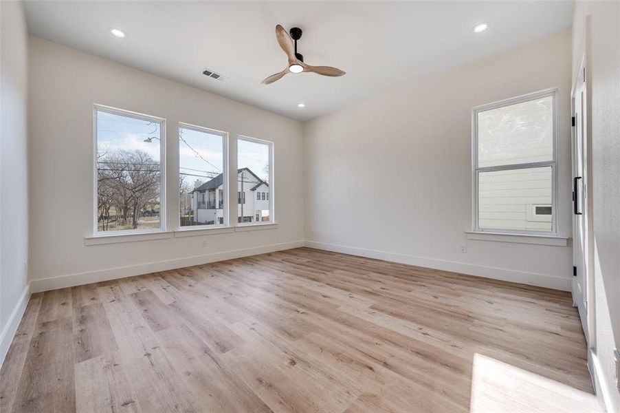 Unfurnished room with light wood finished floors and a ceiling fan