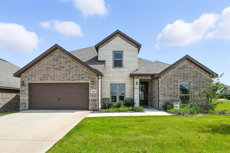 French country style house featuring an attached garage, concrete driveway, stone siding, and a front lawn