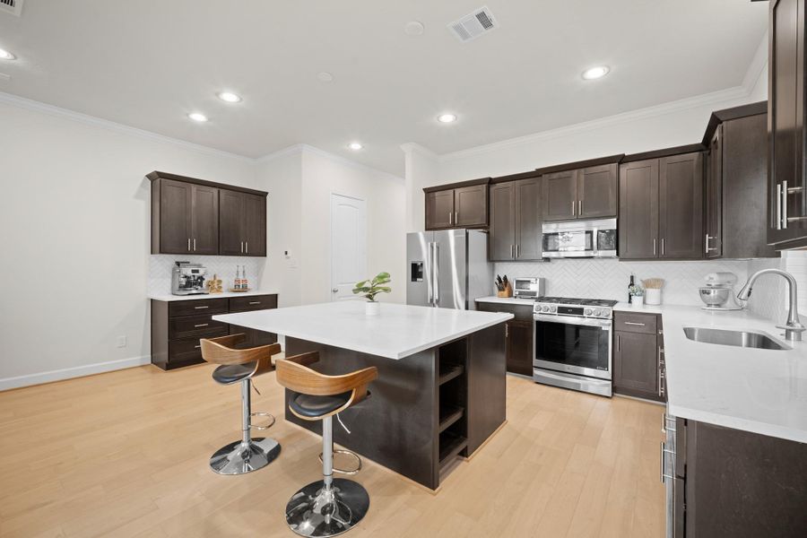 Quartz island with built-in wine storage, LG appliance suite, herringbone tile backsplash, and a dedicated coffee bar — this kitchen was designed with the way people actually live in mind. Quartz island with built-in wine storage, LG appliance suite, herringbone tile backsplash, and a dedicated coffee bar — this kitchen was designed with the way people actually live in mind.