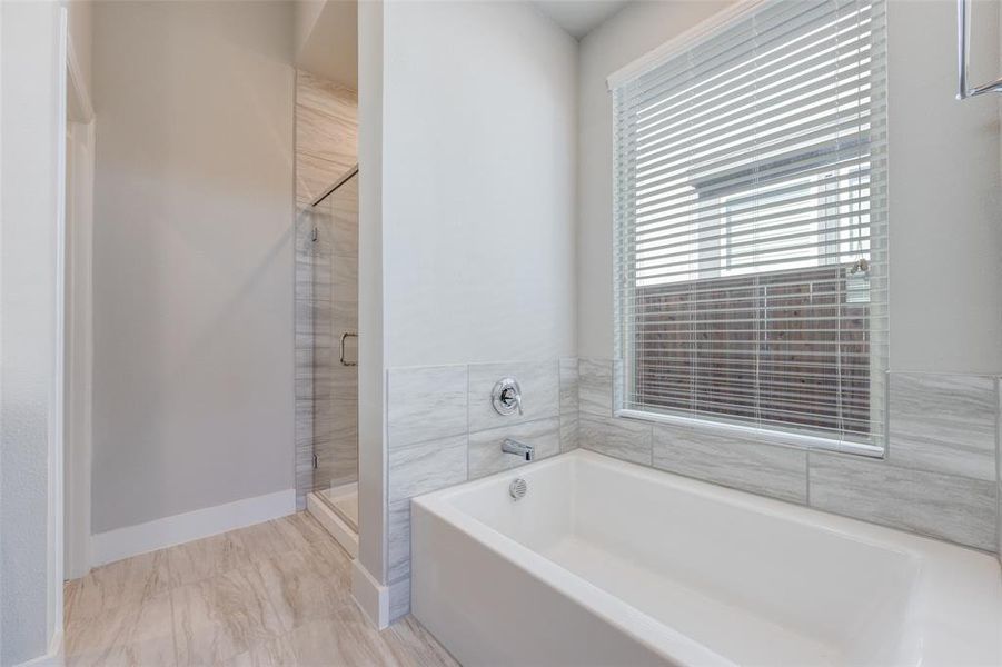 Bathroom with a garden tub and a stall shower