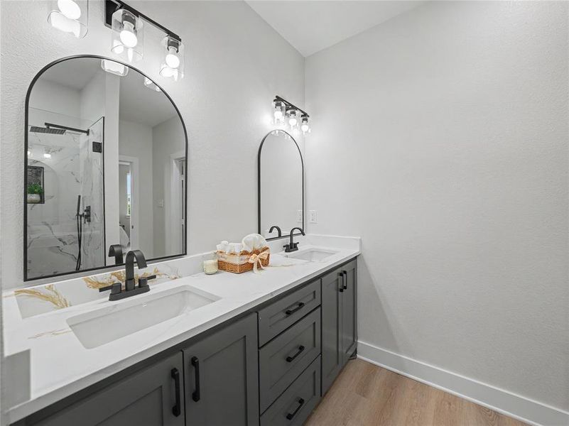 Bathroom vanity featuring dual undermount sinks with matte black faucets