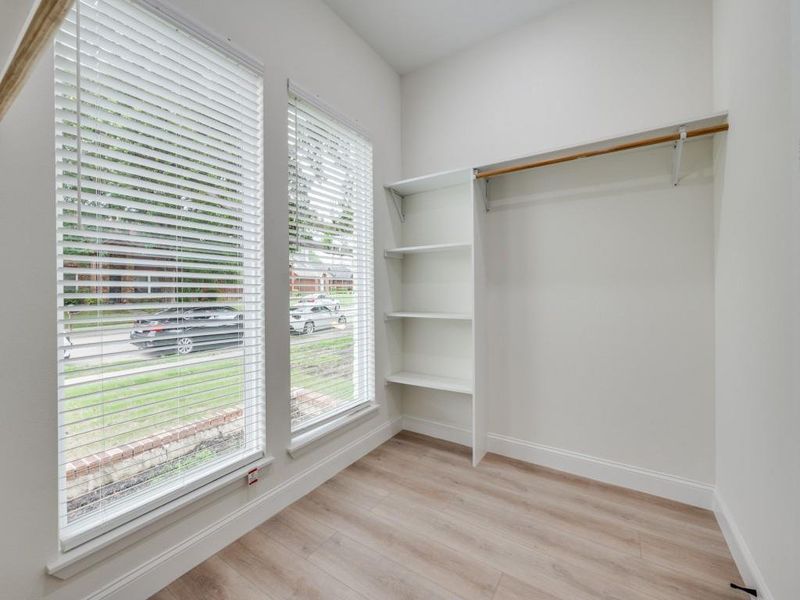 Spacious closet with light wood finished floors