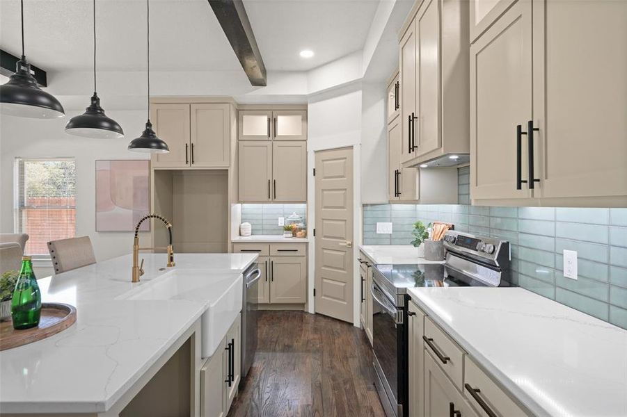 Gourmet kitchen featuring a large island with an integrated farmhouse sink, quartz countertops, light-toned cabinetry with matte black hardware, and a subway tile backsplash Gourmet kitchen featuring a large island with an integrated farmhouse sink, quartz countertops, light-toned cabinetry with matte black hardware, and a subway tile backsplash