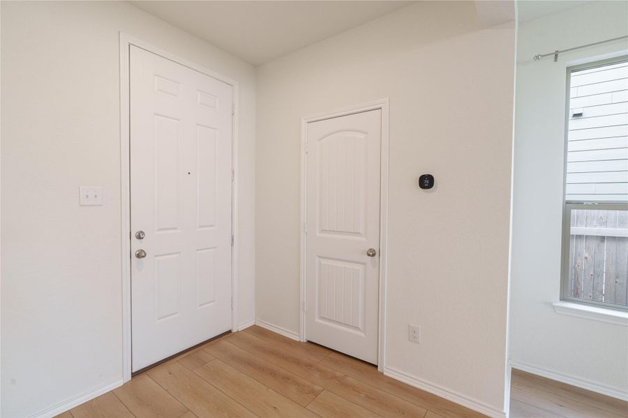 A welcoming entryway with gleaming wood flooring and crisp white doors offers a bright first impression. A welcoming entryway with gleaming wood flooring and crisp white doors offers a bright first impression.