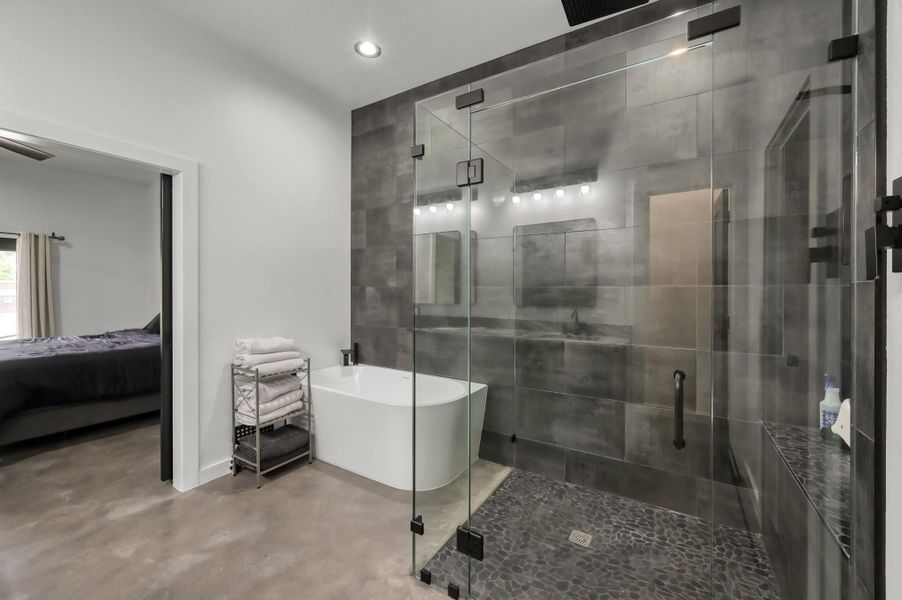 Seperate large glass-enclosed shower and a freestanding bathtub.