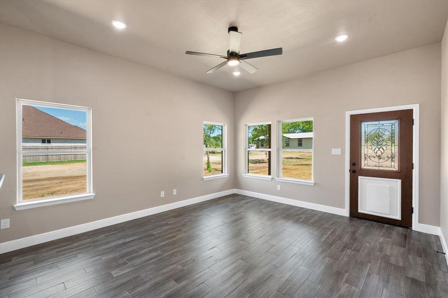 Living room featuring a doggy door with decorative glass that leads to covered patio in backyard