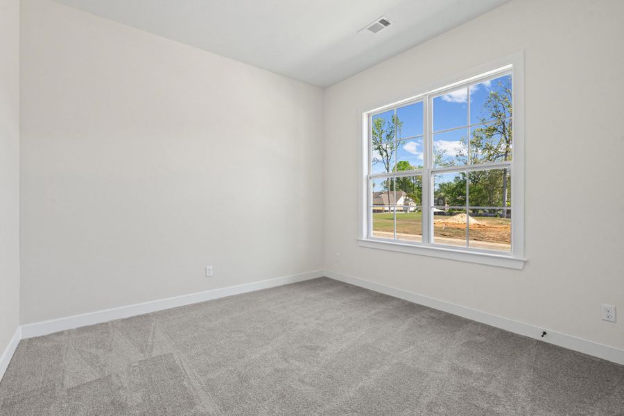 Spare room with light carpet and baseboards