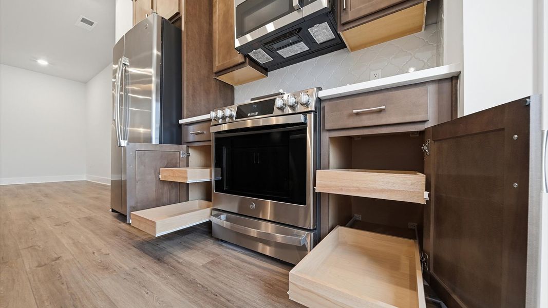 First-rate kitchen with functional layout, abundant storage, and stainless steel appliances by DRB Homes First-rate kitchen with functional layout, abundant storage, and stainless steel appliances by DRB Homes