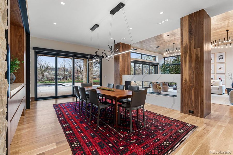 Similar to the adjacent living room, the dining room also brings the outdoors in with another multi-panel sliding glass door opening to the south facing backyard. Includes a Hubbardton Forge Cascade LED Pendant chandelier.