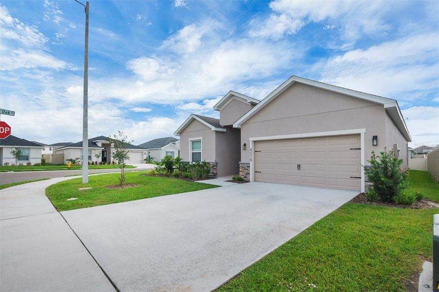 Front exterior of a new home in , Winter Haven, FL, highlighting curb appeal (Image 1). Front exterior of a new home in , Winter Haven, FL, highlighting curb appeal (Image 1).