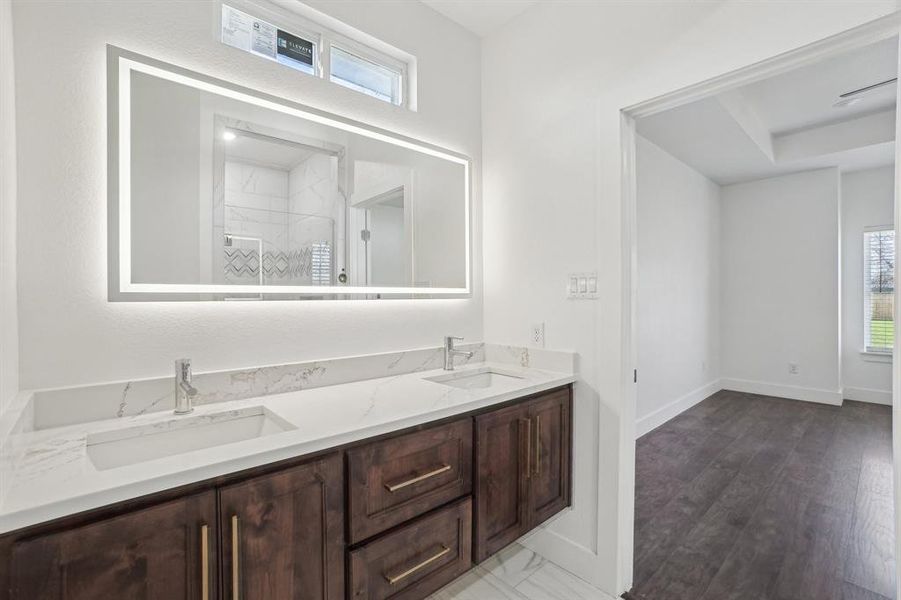 Primary Bathroom with vanity and wood-type flooring