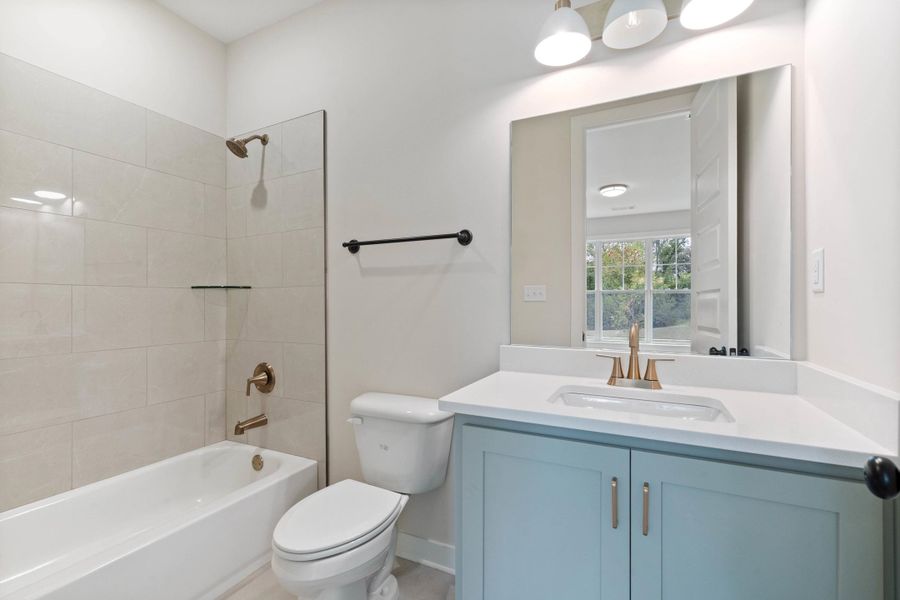 Vanity with light blue cabinetry, under-mount sink, and white countertop Vanity with light blue cabinetry, under-mount sink, and white countertop