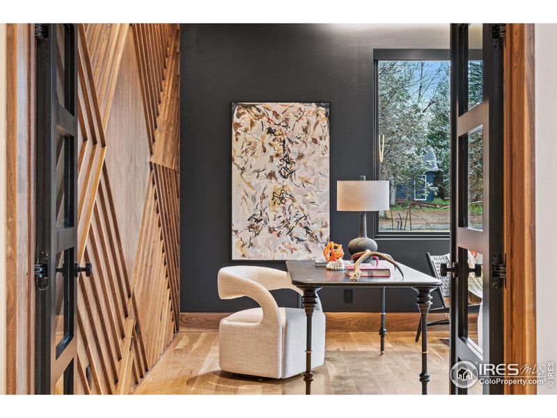 Main floor office with exquisite walnut wall that exudes timeless elegance and warmth.