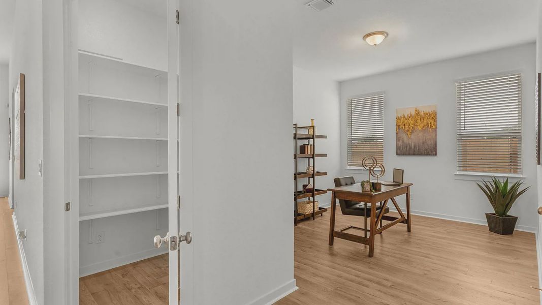 Representative furnished interior of a home built from the Lauren by Chesmar Homes in University Heights, Round Rock (Image 6).