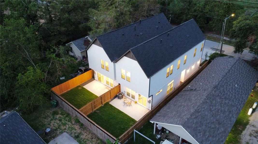 Large private backyard and oversized back patios - perfect for entertaining. Lush trees provide shade and greenery.