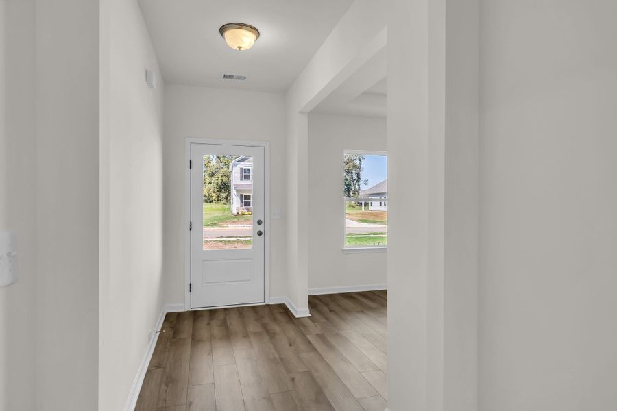 Entry foyer with dining area to the right. Entry foyer with dining area to the right.