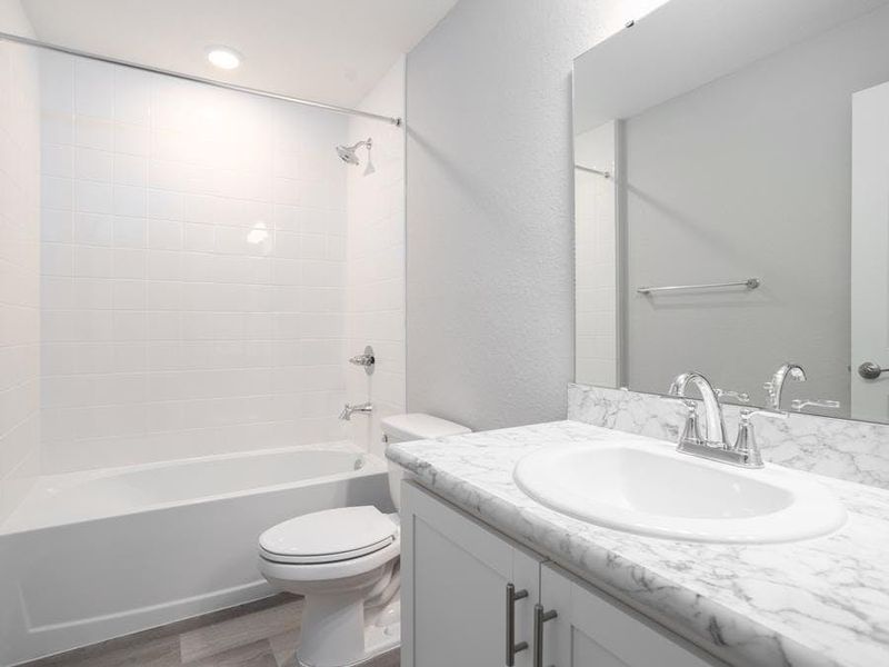 Enjoy the privacy of a hall bath. Photo showcases a home with similar finishes. Color and design options in actual home for sale may differ.