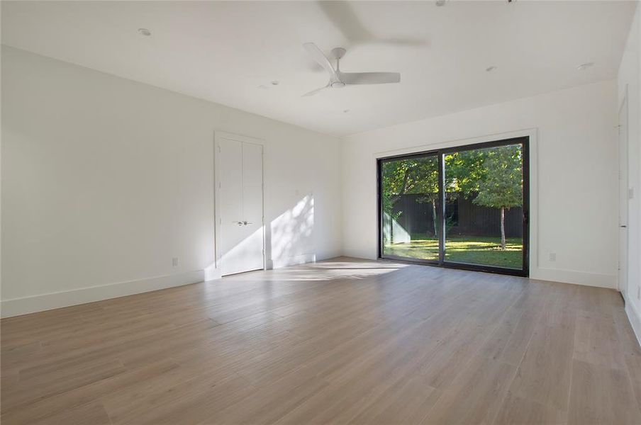 Unfurnished room with ceiling fan and light hardwood / wood-style flooring