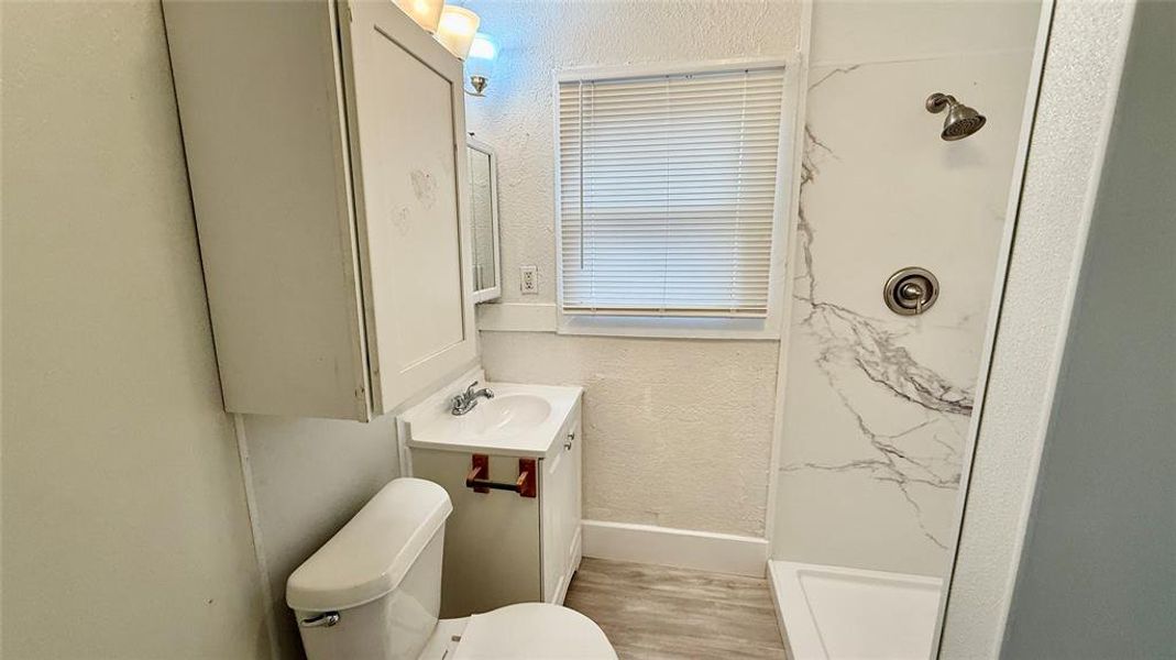 Bathroom with step in shower.