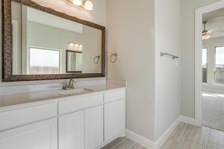 Bathroom featuring vanity and ceiling fan