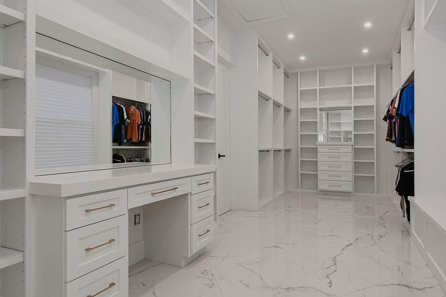 Expansive Primary Closet with Dressing Area and Vanity Expansive Primary Closet with Dressing Area and Vanity