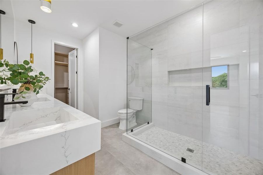 Ensuite bathroom with lwalk in custom closet.