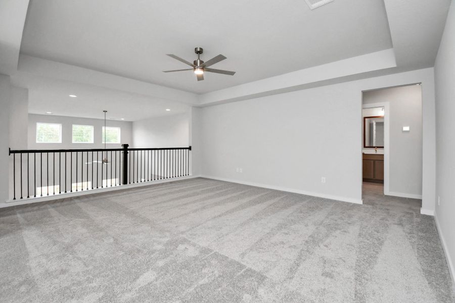 Discover a haven of leisure in this fantastic game room! Whether you're seeking a casual hangout or an adult gaming retreat, this space has it all. Enjoy the luxurious feel of plush carpet underfoot, the expansive ambiance of high ceilings, custom paint that adds a touch of personality, and windows that flood the room with refreshing natural light. Sample photo of completed home with similar floor plan. Actual colors and selections may vary. Discover a haven of leisure in this fantastic game room! Whether you're seeking a casual hangout or an adult gaming retreat, this space has it all. Enjoy the luxurious feel of plush carpet underfoot, the expansive ambiance of high ceilings, custom paint that adds a touch of personality, and windows that flood the room with refreshing natural light. Sample photo of completed home with similar floor plan. Actual colors and selections may vary.