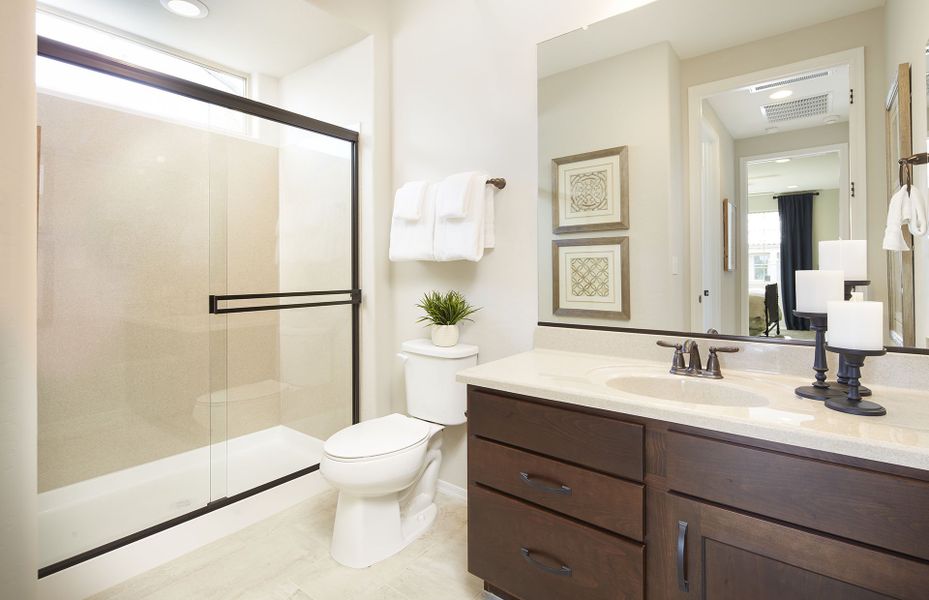 This Guest Bath Includes Storage Space and a Beautiful Shower