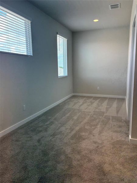 Carpeted empty room featuring baseboards and recessed lighting