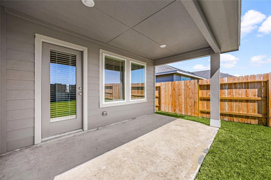 Enjoy a relaxing outdoor retreat under the covered patio, perfect for morning coffee or evening gatherings. The fenced backyard offers privacy and plenty of space for outdoor activities.